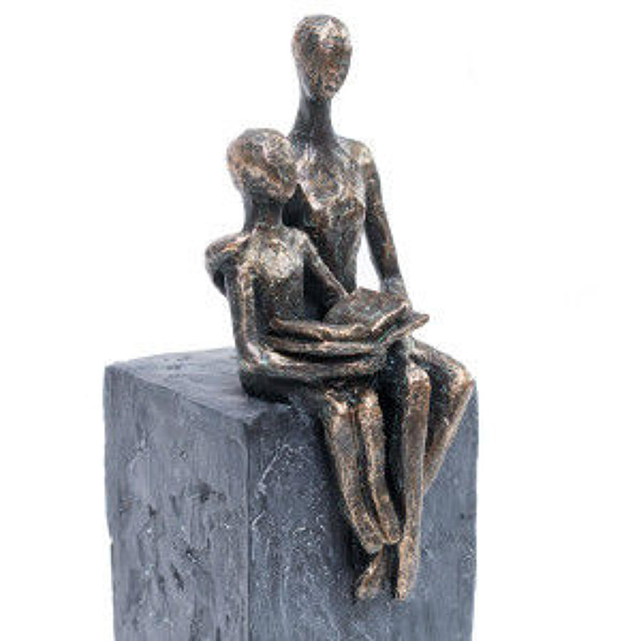 Mother and child reading sculpture